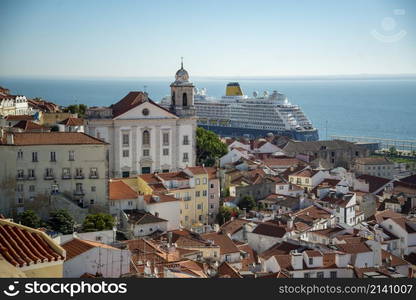 a Tourism Cruise Ship at the Port in front of the Old Town Alfama of the city Lisbon in Portugal. Portugal, Lisbon, October, 2021