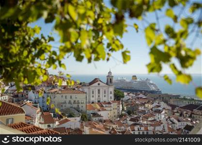 a Tourism Cruise Ship at the Port in front of the Old Town Alfama of the city Lisbon in Portugal. Portugal, Lisbon, October, 2021