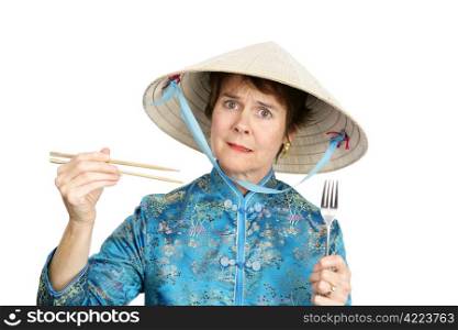 A tourist in Chinatown confused about whether to eat with a fork. Isolated on white.