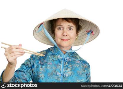 A tourist in Chinatown confused by chopsticks. Isolated on white.
