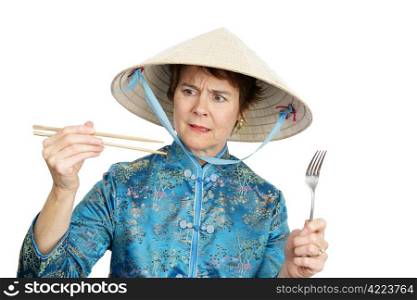 A tourist in Chinatown deciding whether to eat with chopsticks or a fork. Isolated on white.