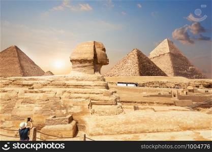 A tourist in Giza enjoying the Sphinx and the Pyramids, Egypt.. A tourist in Giza enjoying the Sphinx and the Pyramids, Egypt