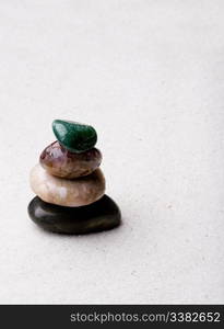 A tower of rocks in a very minimalist zen rock garden