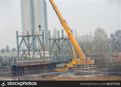 A track crane working in a industrial construction area. Track crane working in a industrial construction area