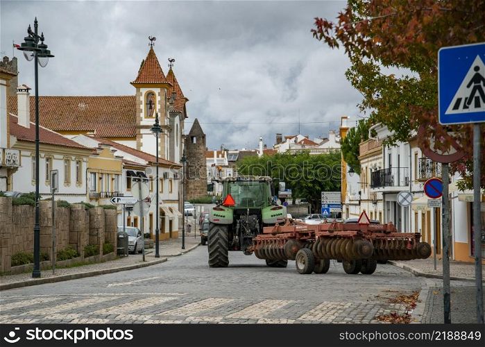 a tractor at the road in the Village of Alter do Chao in Alentejo in Portugal. Portugal, Alter do Chao, October, 2021