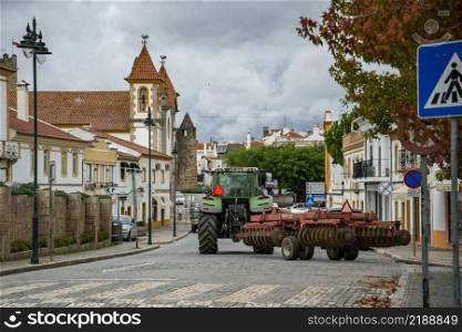 a tractor at the road in the Village of Alter do Chao in Alentejo in Portugal. Portugal, Alter do Chao, October, 2021