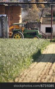 a tractor parked in the middle of a farm, to harvest
