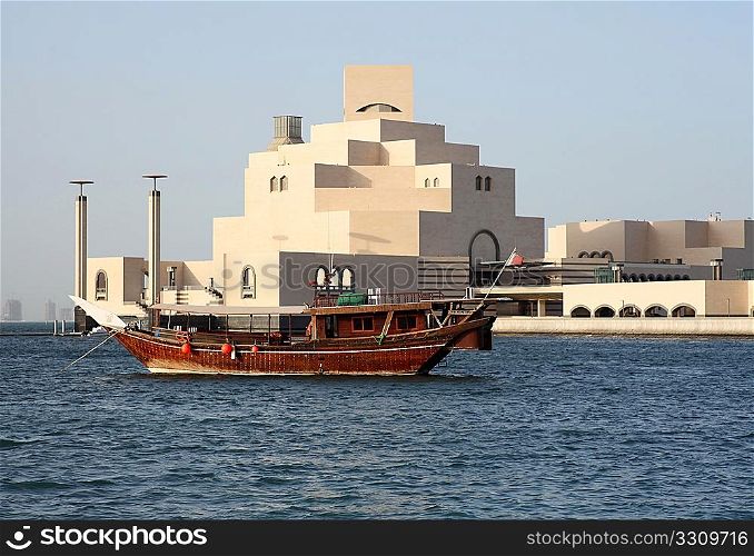 A traditional Arab dhow, of a kind still commonly used in the Arabian/Persian Gulf, anchored in front of the new Museum of Islamic Art in Doha, Qatar, September 26, 2009