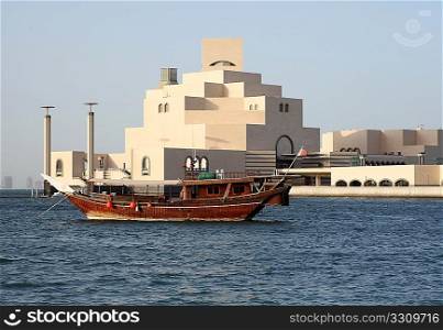 A traditional Arab dhow, of a kind still commonly used in the Arabian/Persian Gulf, anchored in front of the new Museum of Islamic Art in Doha, Qatar, September 26, 2009