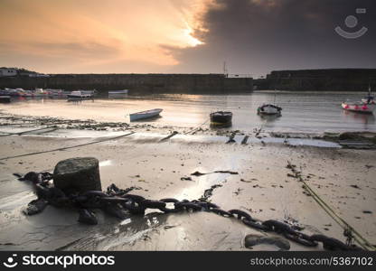 A traditional Cornish fishing village at sunrise in Cornwall England