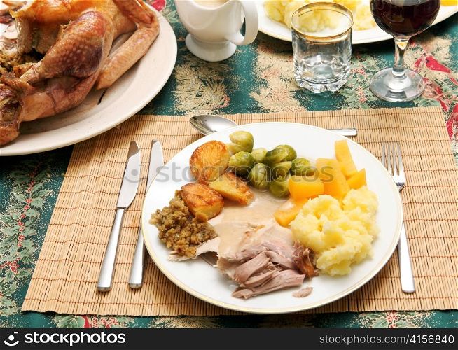 A traditional festive dinner of turkey, roast and boiled potatoes, brussels&acute; sprout, swede, stuffing and gravy
