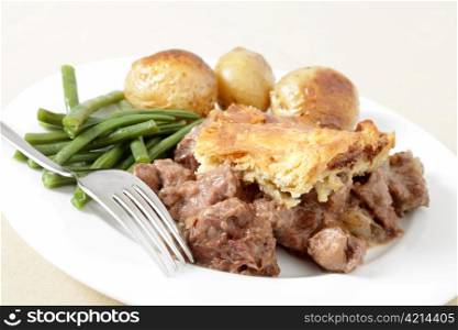 A traditional, home-made steak and kidney pie served with oven roasted potatoes and haricot beans.