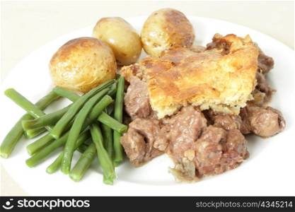 A traditional, home-made steak and kidney pie served with oven roasted potatoes and haricot beans.