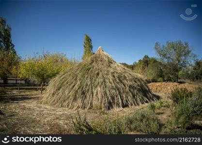 a traditional House of the People at the Ebora Megalithica and Cromlech of Almendres in Almendres near the city of Evora in Alentejo in Portugal. Portugal, Evora, October, 2021