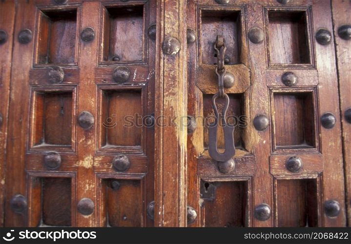 a traditional Wood Door in the Old Town of Stone Town on the Island of Zanzibar in Tanzania. Tanzania, Zanzibar, Stone Town, October, 2004