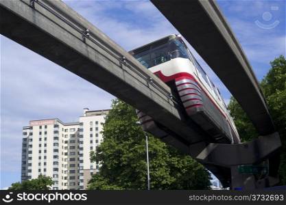 A train passes overhead via elevated rail