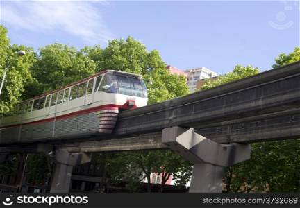 A train passes overhead via elevated rail in downtown Seattle