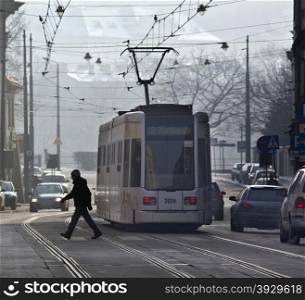 A tram on a busy street in the city of Krakow in Poland.