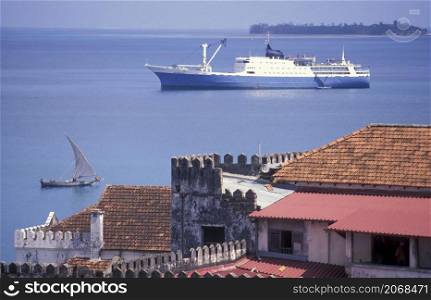 a Transport boat and Ferry at the Indian Ocean in front of the Old Town of Stone Town on the Island of Zanzibar in Tanzania. Tanzania, Zanzibar, Stone Town, October, 2004