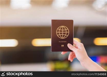 A traveler holding passport in airport