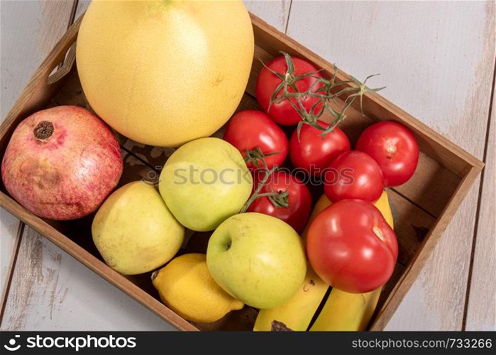 a tray with various seasonal fruits and vegetables