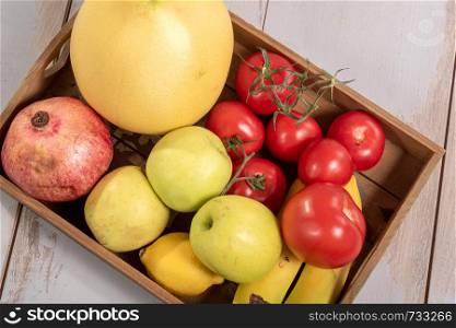 a tray with various seasonal fruits and vegetables