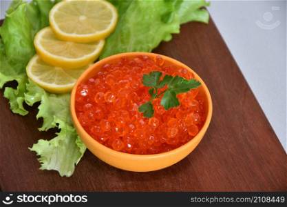 A treat with red caviar and fresh herbs for Orthodox Christmas
