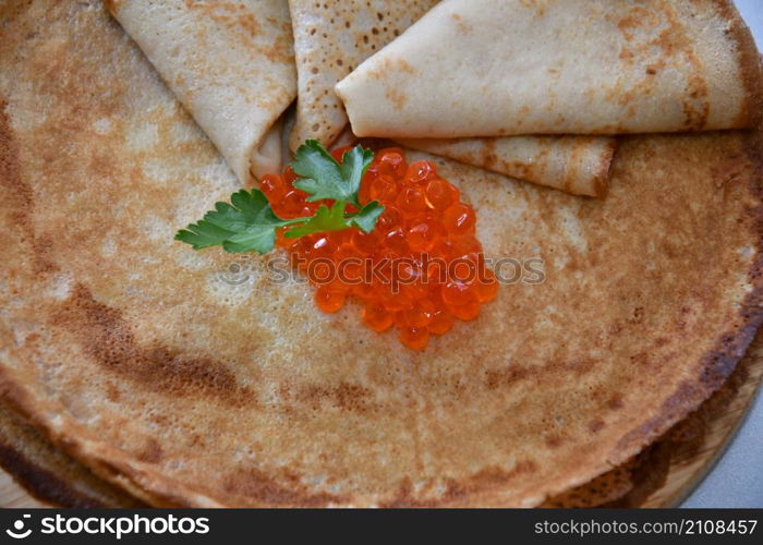 A treat with red caviar and fresh herbs for Orthodox Christmas