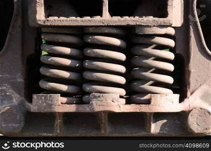a trio of heavy-duty springs on the side of a train car