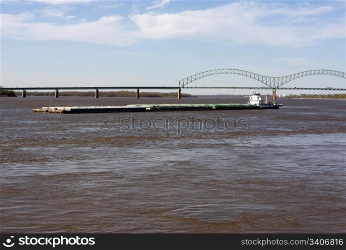 A tug boat pushes a barge on the Mississippi River at Memphis, Tennessee.