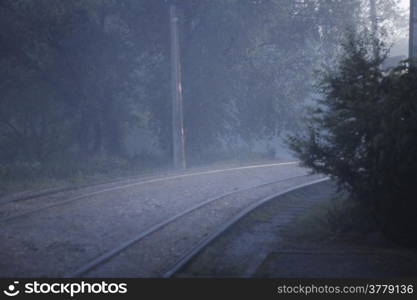 A Twisted railroad in the foggy evening