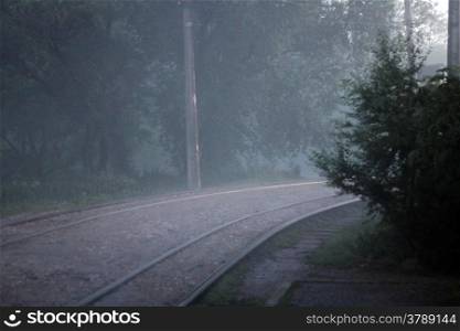 A Twisted railroad in the foggy evening