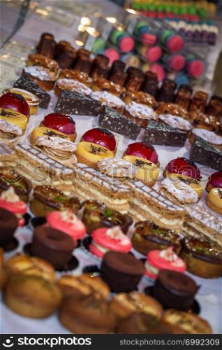 A variety of cakes on display at a market cake stall