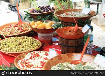 A variety of French delicacies like olives, tapenade and marinated garlic on a local market in Bedoin, France