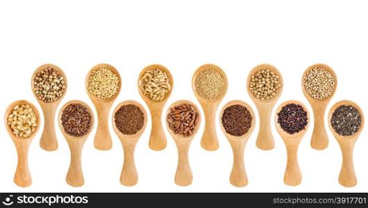 a variety of gluten free grains (buckwheat, amaranth, brown rice, millet, sorghum, teff, black, white and black quinoa, chia seeds, flax seeds) on wooden spoons isolated on white
