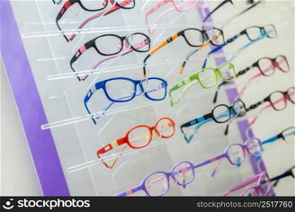 a variety of medical and sunglasses on the stand in the store. eye glasses on the stand