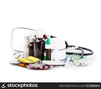 A variety of medicine and stethoscope on white background