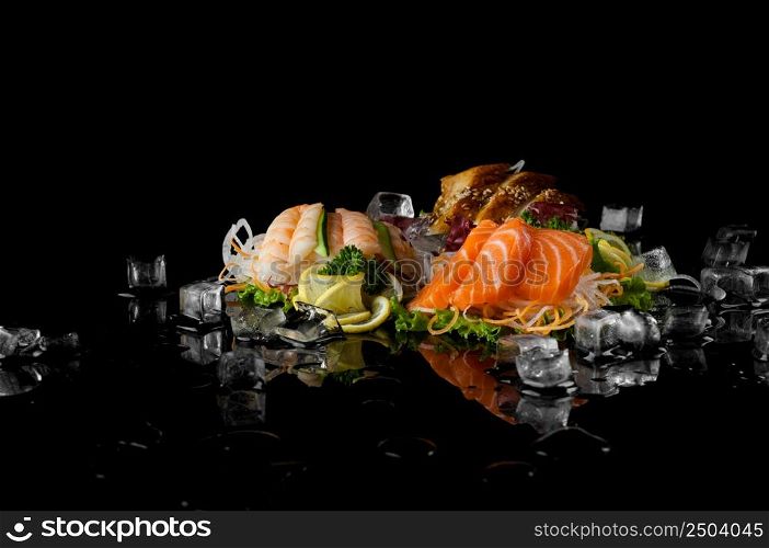 a variety of sushi with pieces of melting ice on a black background with reflection. sushi on black background