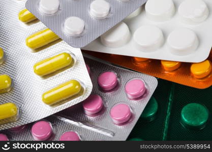 A variety of tablets in packs on background, treatment