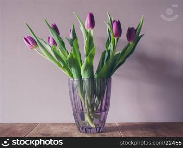 A vase with purple tulips