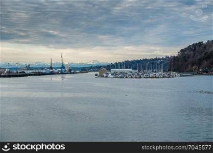 A veiw of a Tacoma marina with the Olympic Mountains in the distance.