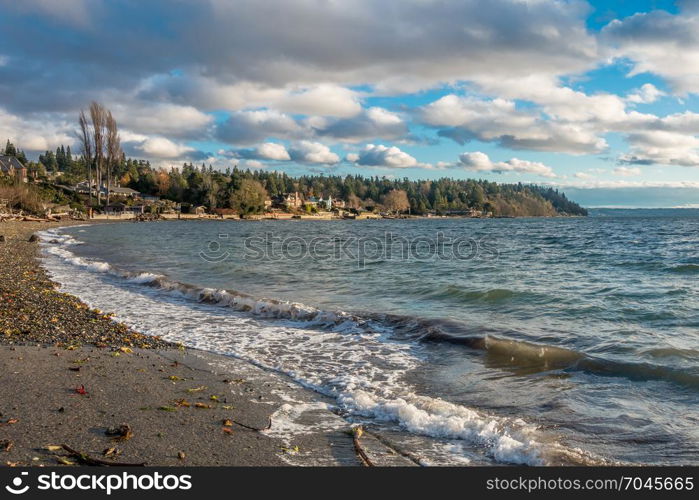 A veiw of the shoreline in Normandy Park, Washington. Wispy clouds hover above.