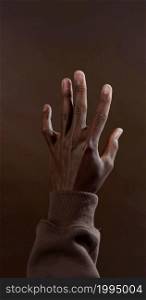 A vertical photo of a black hand
