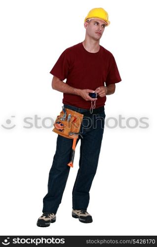 A very annoyed tradesman holding a chalk line
