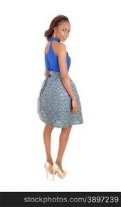 A very beautiful slim African American woman standing in a lovely skirtand blue blouse isolated for white background.