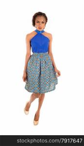 A very beautiful slim African American woman standing in a lovely skirtand blue blouse isolated for white background.