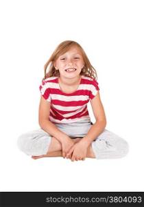 A very happy young girl sitting smiling on the floor in the studio,isolated on white background.