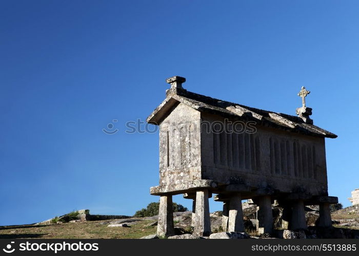 A very old corn drier, made of stone isolated over blue sky background