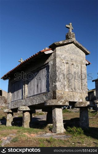 A very old corn drier, made of stone isolated over blue sky background