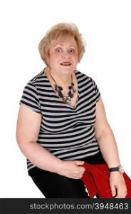 A very surprised looking senior woman sitting on a chair with big eye&rsquo;s,isolated for white background.